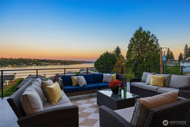 8553 NE Juanita Dr, Kirkland, WA 98034 - patio terrace at dusk with an outdoor living space, a water view, and a balcony