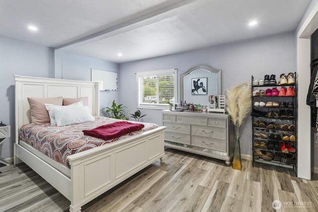 bedroom with light wood finished floors and recessed lighting