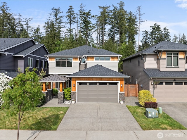13127 184th Ave E, Bonney Lake, WA 98391 - view of front of home featuring driveway, stone siding, an attached garage, and roof with shingles