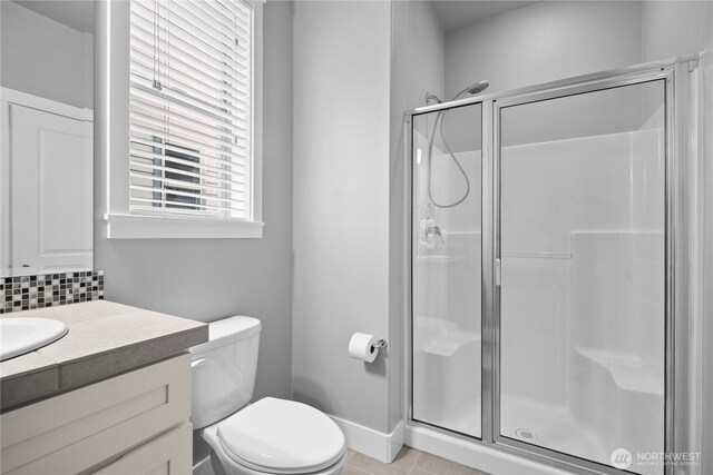13127 184th Ave E, Bonney Lake, WA 98391 - full bathroom with a shower stall, toilet, vanity, and tile patterned flooring