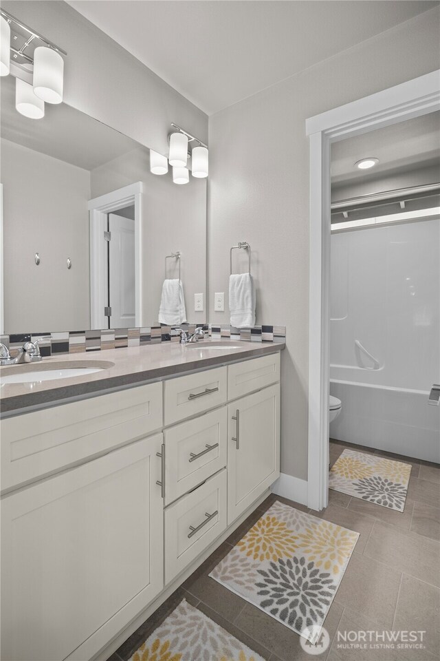 13127 184th Ave E, Bonney Lake, WA 98391 - bathroom featuring double vanity, tile patterned floors, bathing tub / shower combination, and toilet