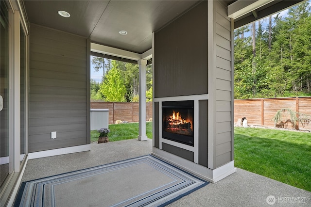 13127 184th Ave E, Bonney Lake, WA 98391 - view of patio / terrace featuring a lit fireplace