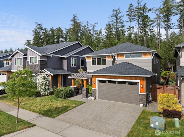 13127 184th Ave E, Bonney Lake, WA 98391 - view of front facade with stone siding, board and batten siding, a garage, a shingled roof, and driveway