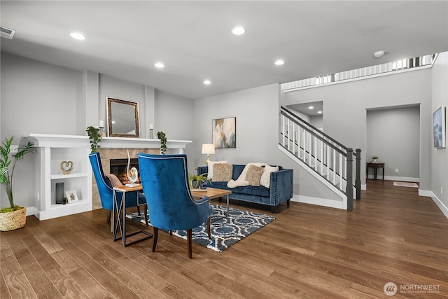 13127 184th Ave E, Bonney Lake, WA 98391 - living room with wood finished floors, stairs, baseboards, a tiled fireplace, and recessed lighting