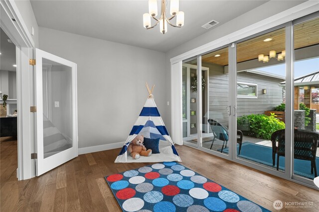 13127 184th Ave E, Bonney Lake, WA 98391 - rec room with wood finished floors and a chandelier