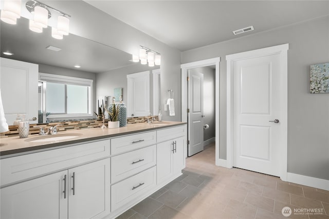 13127 184th Ave E, Bonney Lake, WA 98391 - bathroom featuring double vanity, baseboards, and recessed lighting