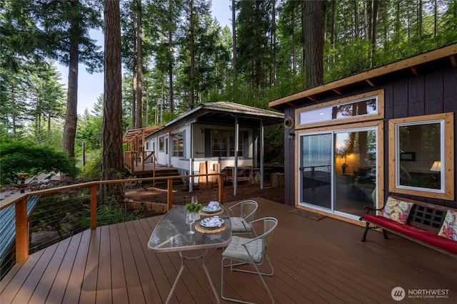 1059 Island Dr, Lummi Island, WA 98262 - wooden deck featuring outdoor dining space and an outbuilding