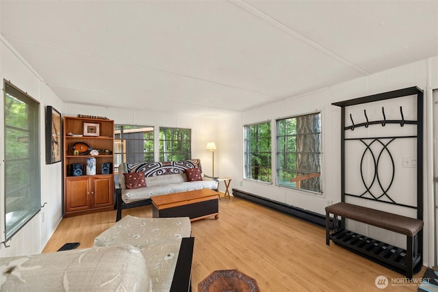 1059 Island Dr, Lummi Island, WA 98262 - bedroom with wood finished floors, a baseboard radiator, and multiple windows