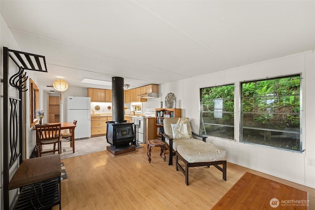 1059 Island Dr, Lummi Island, WA 98262 - living area featuring a wood stove and light wood-style flooring