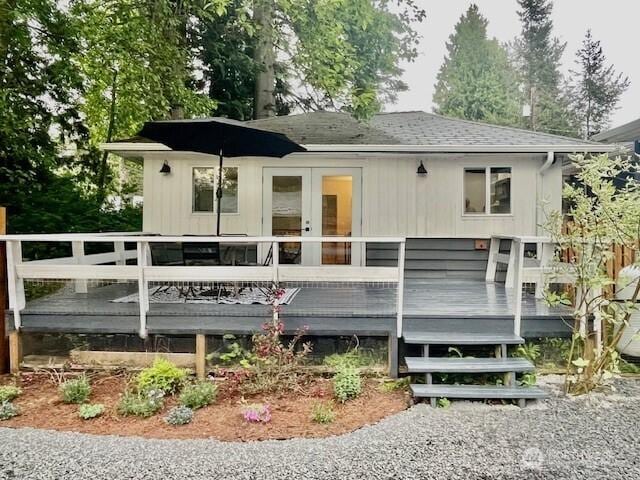 8293 Beachway Dr, Blaine, WA 98230 - back of property with a shingled roof, a wooden deck, and french doors