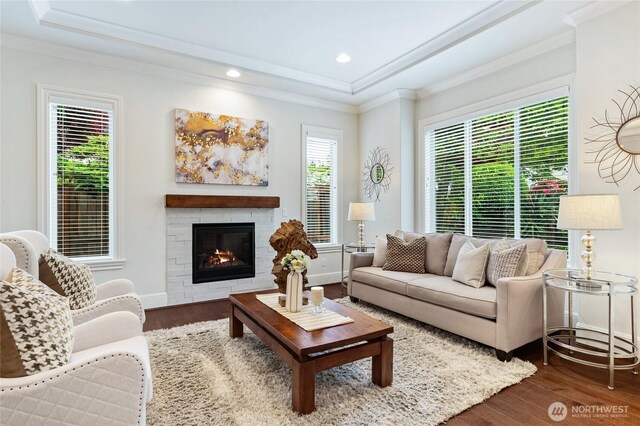 9827 NE 20th St, Bellevue, WA 98004 - living area with a raised ceiling, dark wood-style flooring, a glass covered fireplace, recessed lighting, and crown molding