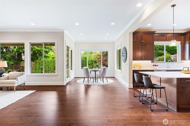 9827 NE 20th St, Bellevue, WA 98004 - dining room with dark wood-type flooring, ornamental molding, recessed lighting, and baseboards