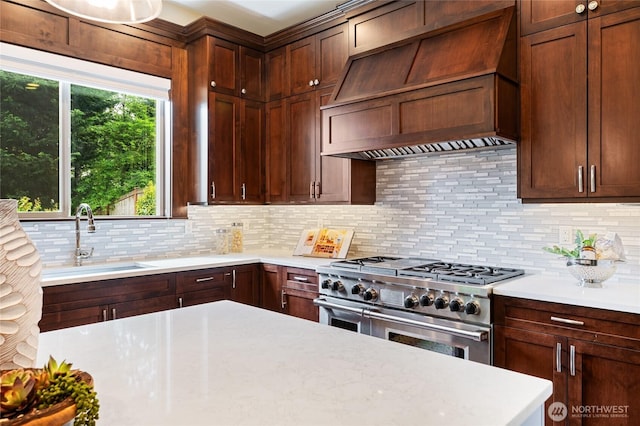 9827 NE 20th St, Bellevue, WA 98004 - kitchen featuring range with two ovens, custom exhaust hood, a sink, light countertops, and tasteful backsplash