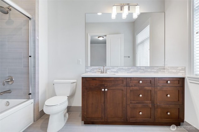 9827 NE 20th St, Bellevue, WA 98004 - bathroom featuring toilet, vanity, decorative backsplash, combined bath / shower with glass door, and tile patterned flooring