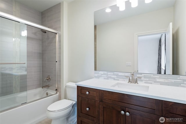9827 NE 20th St, Bellevue, WA 98004 - bathroom featuring toilet, vanity, backsplash, and bath / shower combo with glass door
