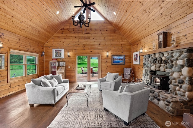 5410 SW 244th St, Vashon, WA 98070 - living room with healthy amount of natural light, high vaulted ceiling, wood walls, a wood stove, and wood finished floors
