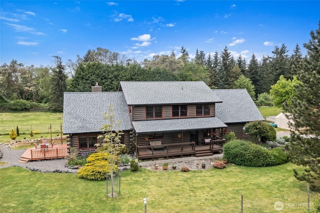 5410 SW 244th St, Vashon, WA 98070 - view of front of house with log siding, a front lawn, and roof with shingles