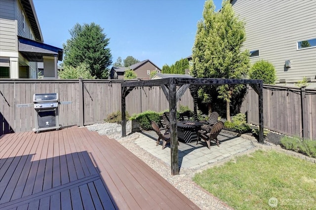 13406 SE 262nd St, Kent, WA 98042 - wooden deck with a fenced backyard, a patio, a grill, and a fire pit
