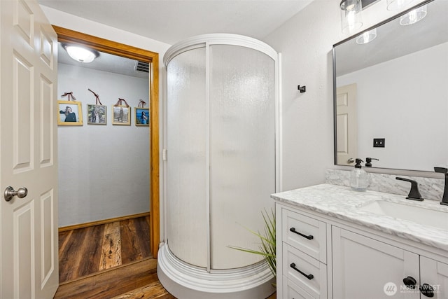 13925 80th St E, Puyallup, WA 98372 - full bathroom featuring vanity, a shower stall, and wood finished floors