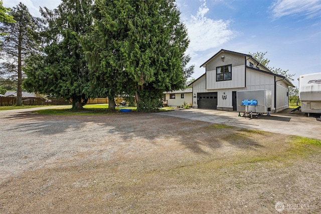 13925 80th St E, Puyallup, WA 98372 - view of front of house with driveway, board and batten siding, and a garage