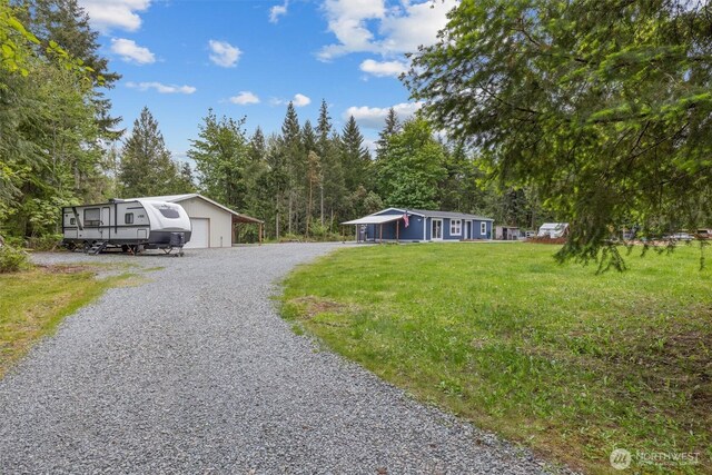 22011 167th St E, Orting, WA 98360 - manufactured / mobile home with driveway, a front lawn, and a detached garage