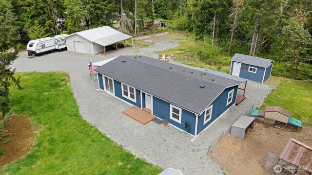aerial view of property and surrounding area with a heavily wooded area