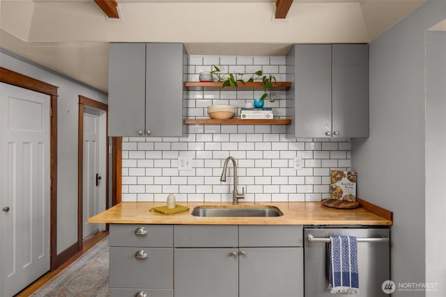 kitchen with gray cabinets, dishwasher, and a sink