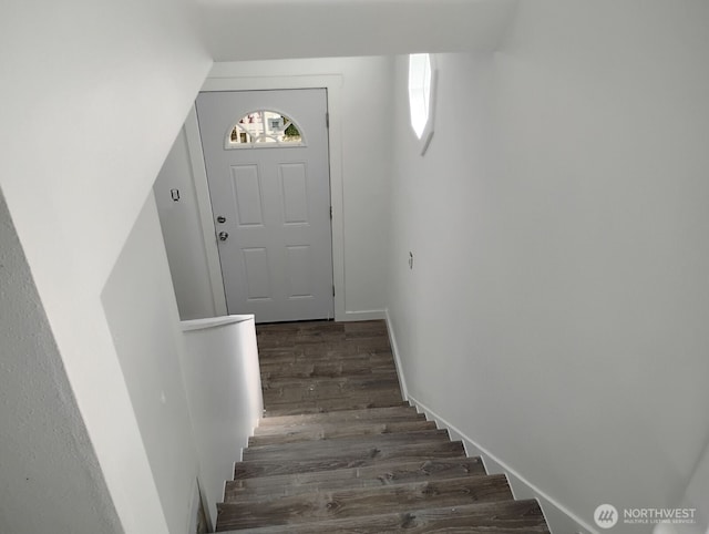 stairs with wood finished floors and baseboards
