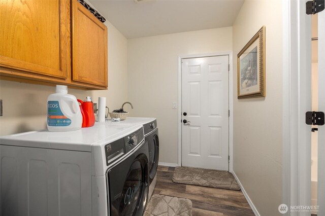 12128 167th Dr NE, Arlington, WA 98223 - washroom with washer and clothes dryer, cabinet space, dark wood finished floors, and baseboards