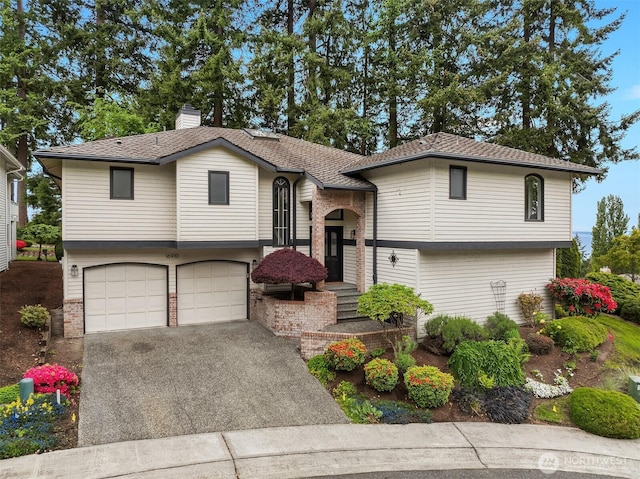 16910 73rd Pl W, Edmonds, WA 98026 - raised ranch featuring a garage, driveway, a chimney, and brick siding