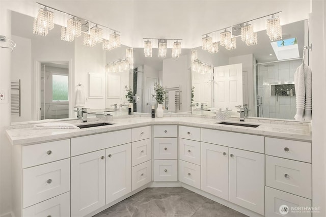 16910 73rd Pl W, Edmonds, WA 98026 - bathroom with marble look tile flooring, a towering ceiling, a shower stall, vanity, and a chandelier