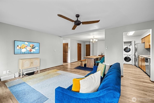 8516 196th St SW Unit 311, Edmonds, WA 98026 - living room with stacked washer / drying machine, ceiling fan, light wood finished floors, and a chandelier