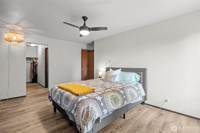 8516 196th St SW Unit 311, Edmonds, WA 98026 - bedroom with wood finished floors, a spacious closet, baseboards, and a ceiling fan