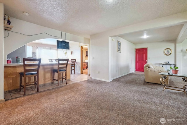237 Reeds Rd, Touchet, WA 99360 - dining space with carpet, a textured ceiling, baseboards, and arched walkways