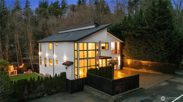 11210 SE 74th St, Newcastle, WA 98056 - back of house with stucco siding, a balcony, a view of trees, and stairs