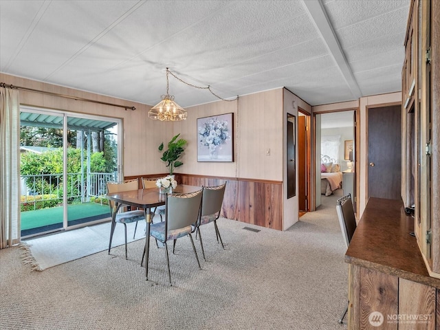 1415 84th St SE Unit 159, Everett, WA 98208 - dining room featuring wood walls, carpet, a chandelier, and a textured ceiling
