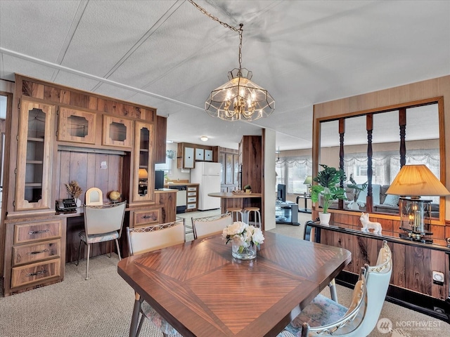 1415 84th St SE Unit 159, Everett, WA 98208 - dining space featuring a chandelier, wood walls, and light colored carpet