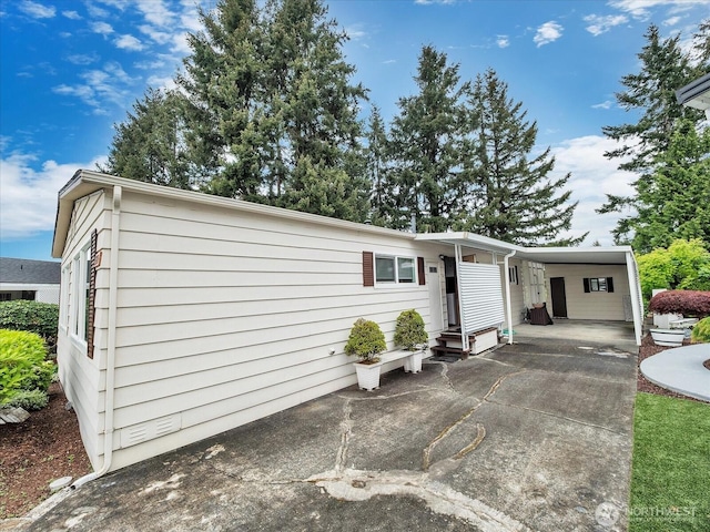 1415 84th St SE Unit 159, Everett, WA 98208 - view of front of house featuring an attached carport, concrete driveway, and entry steps