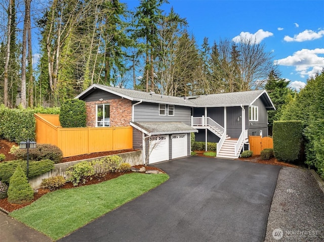 13050 SE 21st Pl, Bellevue, WA 98005 - view of front of property featuring asphalt driveway, an attached garage, stairs, fence, and a shingled roof