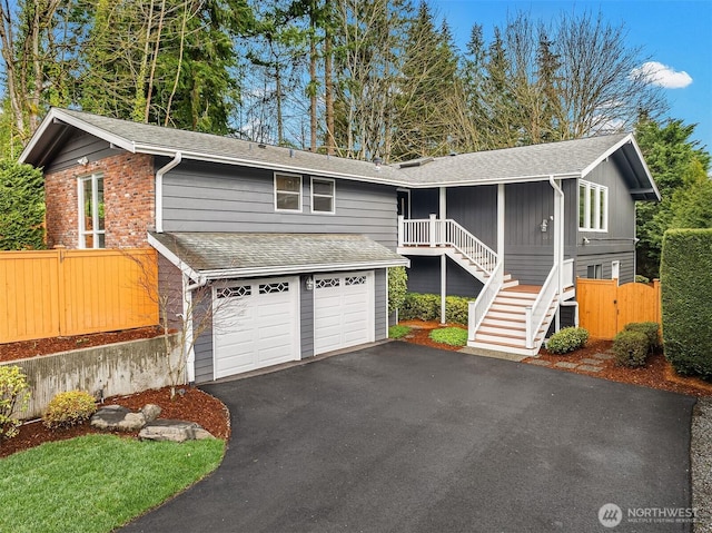13050 SE 21st Pl, Bellevue, WA 98005 - view of front of property with asphalt driveway, roof with shingles, fence, and an attached garage