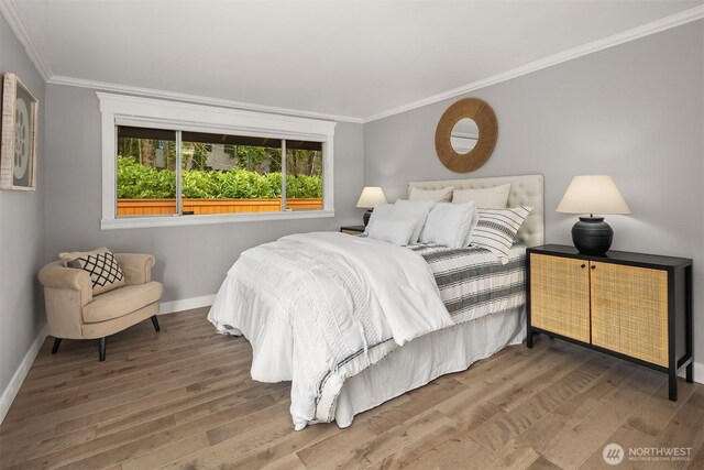13050 SE 21st Pl, Bellevue, WA 98005 - bedroom featuring crown molding, wood finished floors, and baseboards