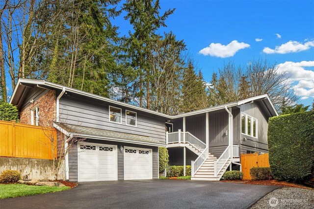 13050 SE 21st Pl, Bellevue, WA 98005 - view of front of property with asphalt driveway, a garage, stairway, and fence