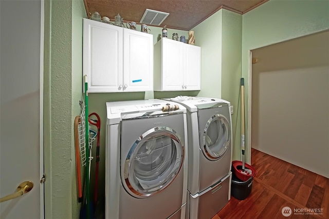 19308 8th St E, Spanaway, WA 09387 - washroom with washer and clothes dryer, dark wood finished floors, and cabinet space