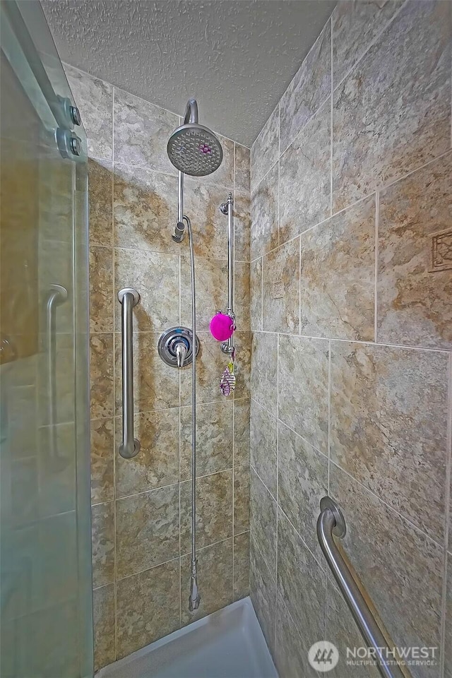 19308 8th St E, Spanaway, WA 09387 - full bathroom featuring a shower stall and a textured ceiling