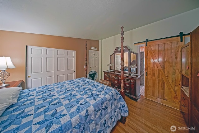 19308 8th St E, Spanaway, WA 09387 - bedroom with wood finished floors and a barn door
