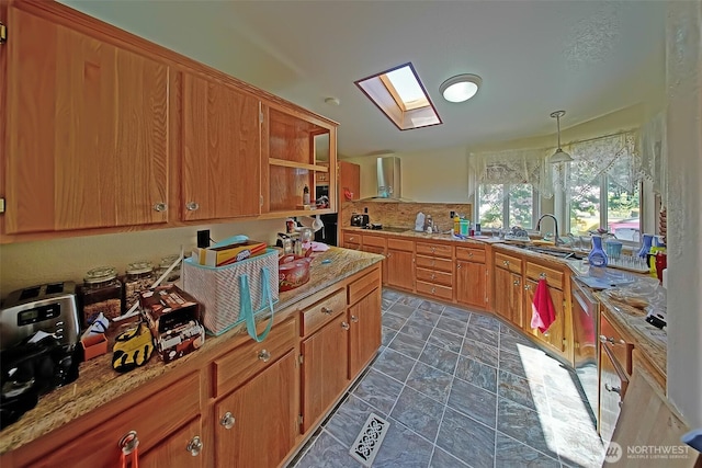 19308 8th St E, Spanaway, WA 09387 - kitchen featuring wall chimney range hood, a skylight, decorative backsplash, black cooktop, and brown cabinetry
