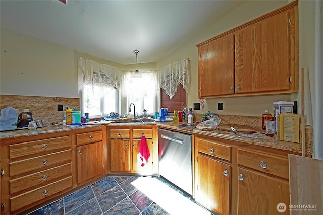 19308 8th St E, Spanaway, WA 09387 - kitchen with stainless steel dishwasher, brown cabinets, stone finish flooring, decorative backsplash, and light countertops