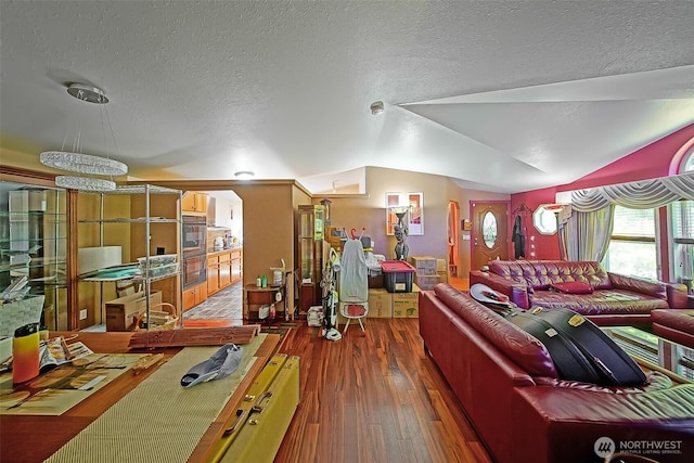 19308 8th St E, Spanaway, WA 09387 - living room with a textured ceiling, hardwood / wood-style floors, and vaulted ceiling