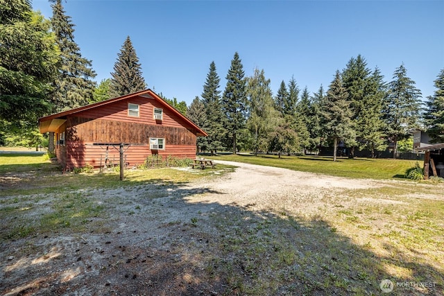 view of side of property with a lawn