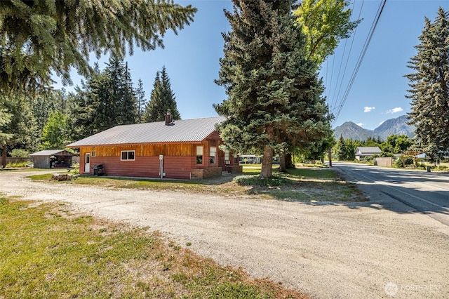 view of front of property featuring a mountain view and metal roof
